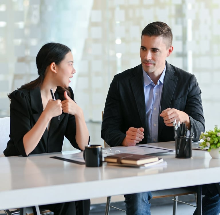 Professional business colleagues in a modern office discuss a project
