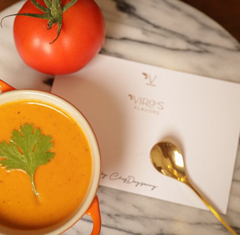 a cup of soup with a tomato soup in a bowl