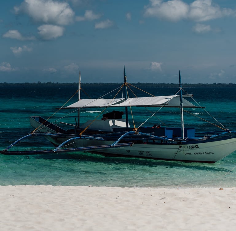 a boat on the beach with a boat in the water