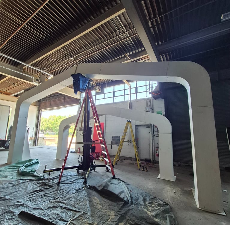 Large arched installation constructed in a warehouse space.