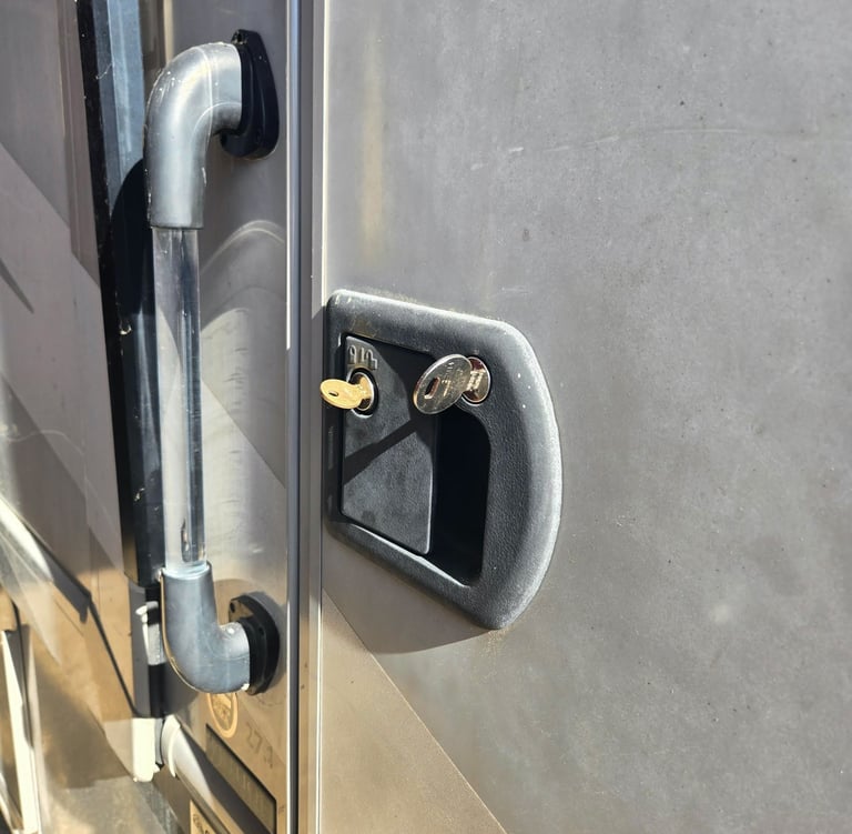 RV entry door handle and lock with key inserted