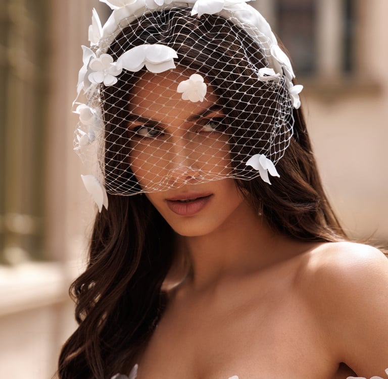 a woman in a wedding dress with a veil and veil