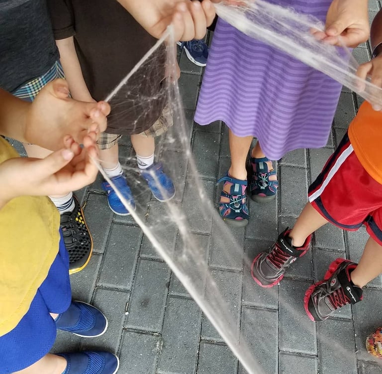 Closeup of children's hands pulling roving while attending the RIngling event.