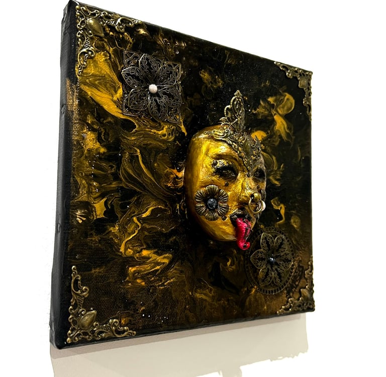 a painting of a gold mask on a white background