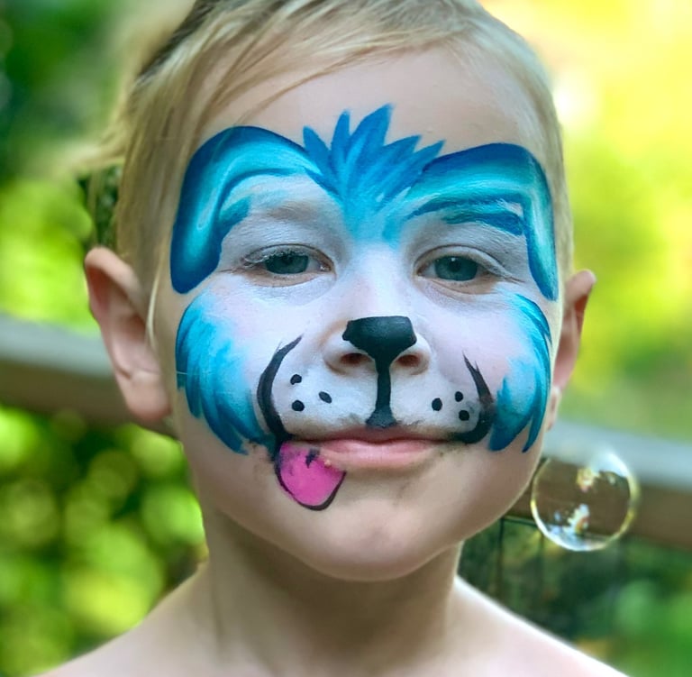 Child with face paint of a blue puppy dog.