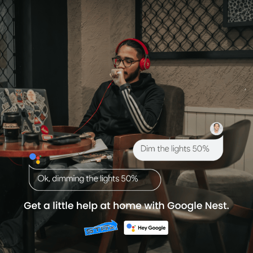 a man sitting at a table with a laptop and headphones