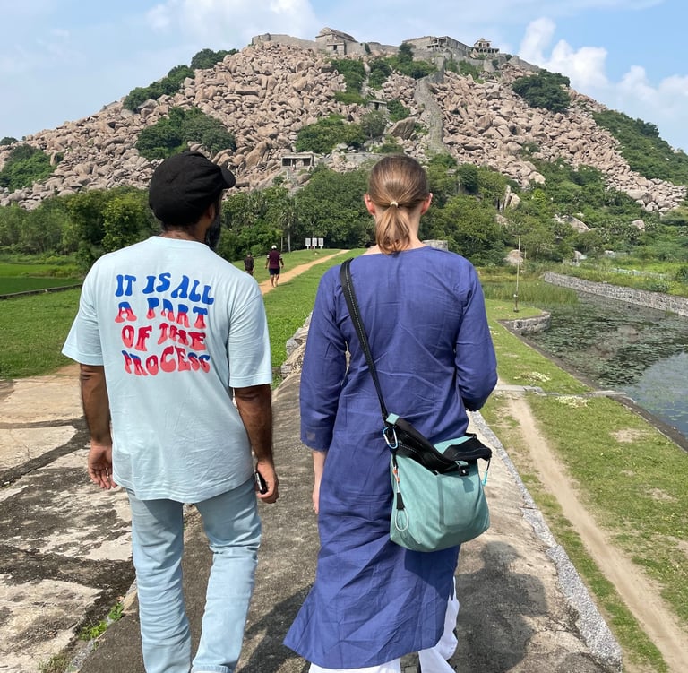 a man and woman walking down a path