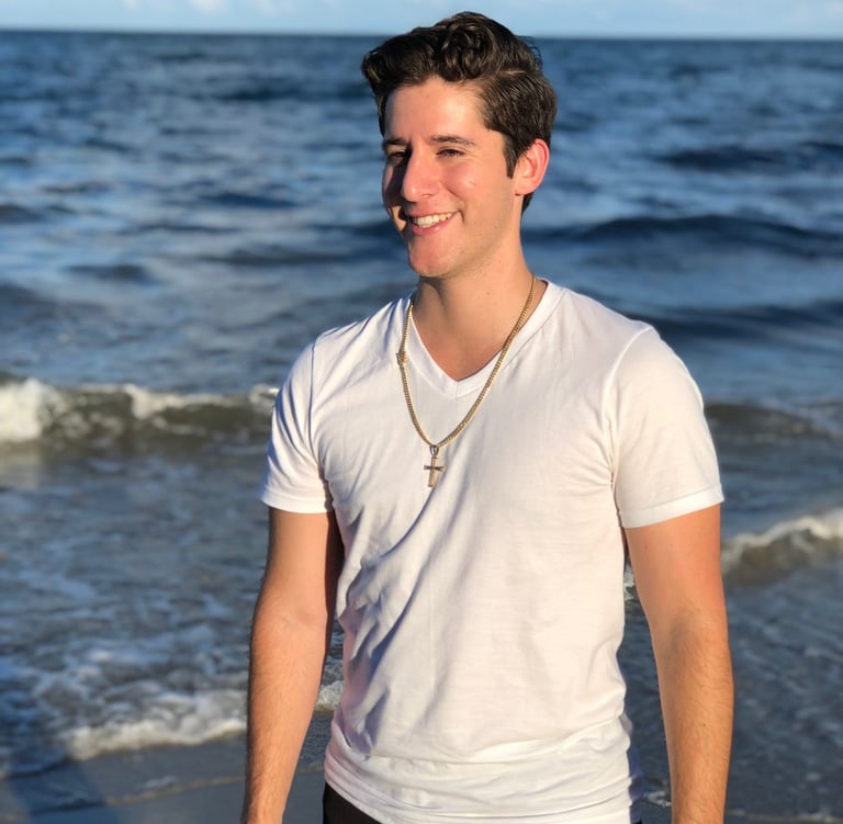 Rene Aviles in a white shirt and black pants