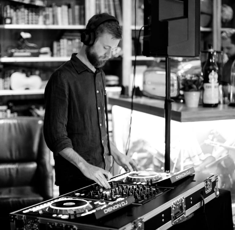 a man in a black shirt and a dj controller