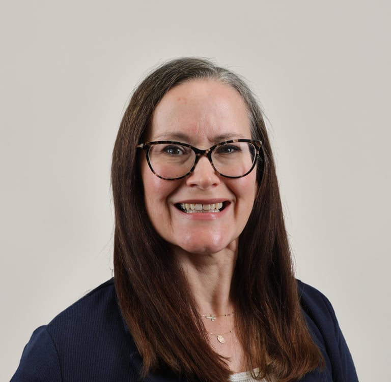 Professional headshot of Christine Masters-Wheeler, a woman with glasses and long brown hair.