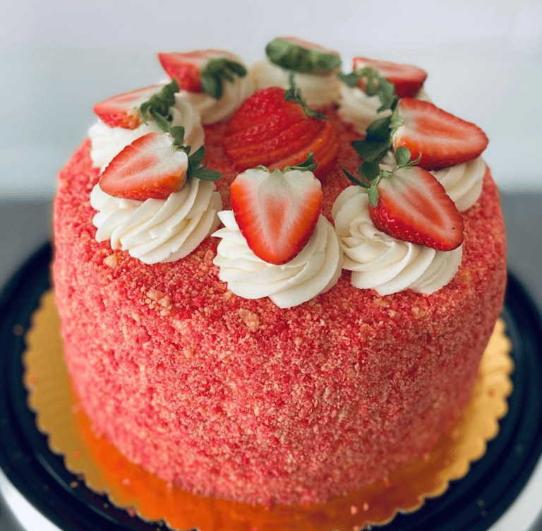 strawberry crunch cake with strawberries and frosting