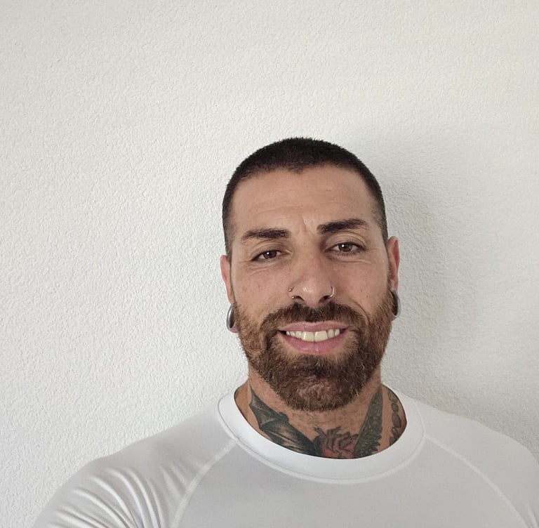 a man with a beard and tattoos on his chest