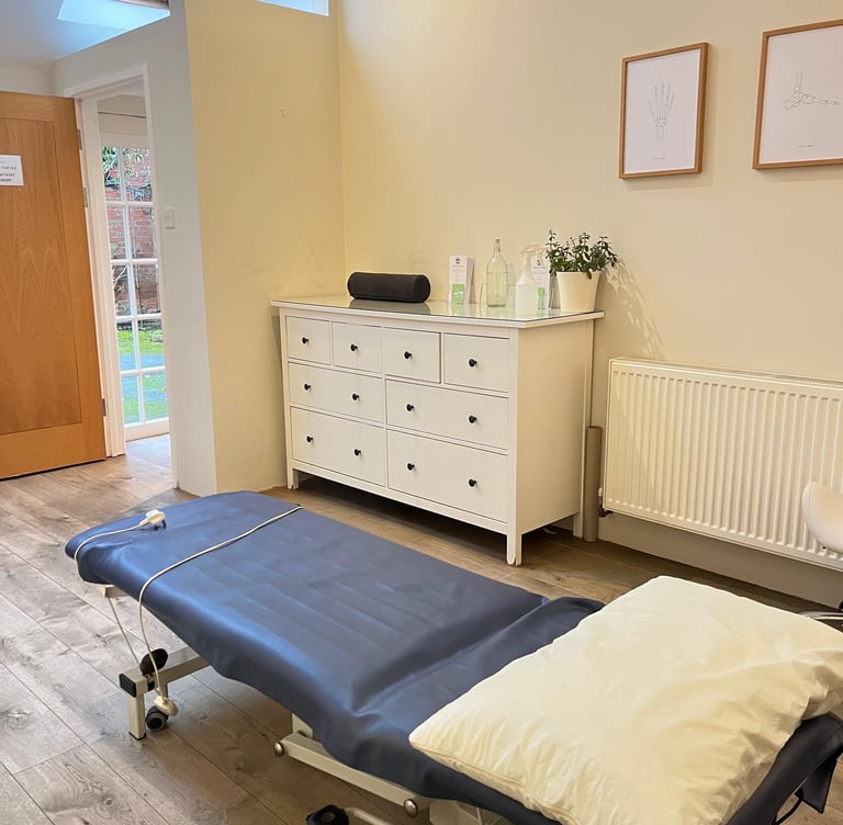 clinic room with wooden floors and patient couch