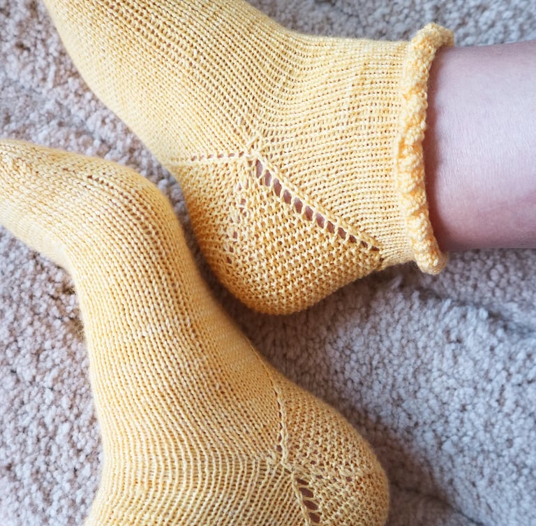 Yellow ruffle Jasmine socks with lace and texture knitting pattern by andie solar