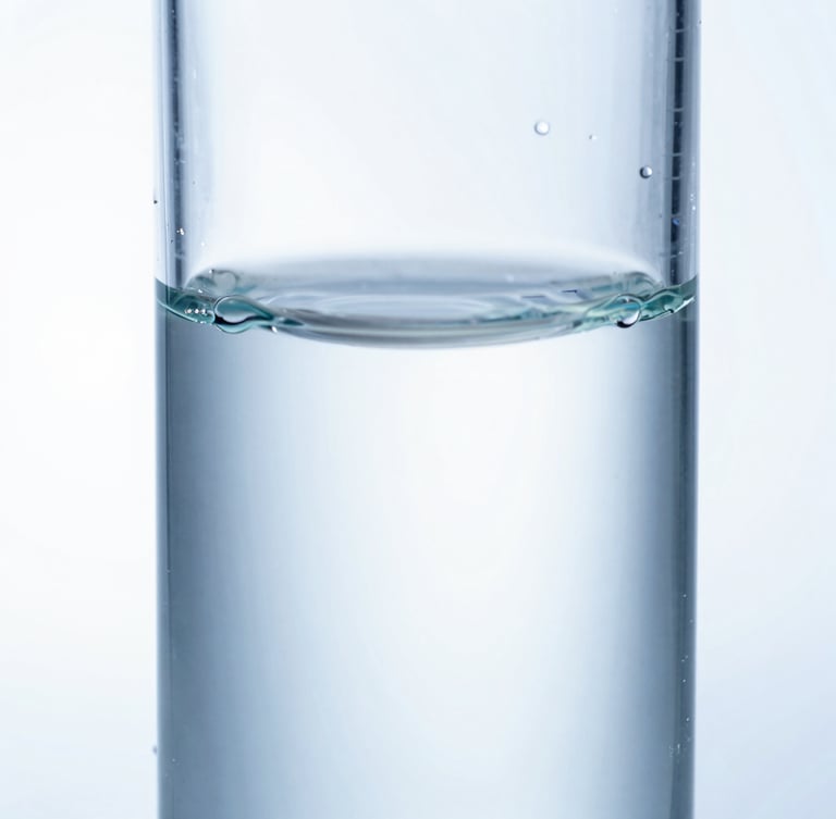 Extreme macro photograph of light refracting through a pure, sterile clear liquid biopolymer in a quartz cuvette, high-key white background, cool blue tones, clinical focus.