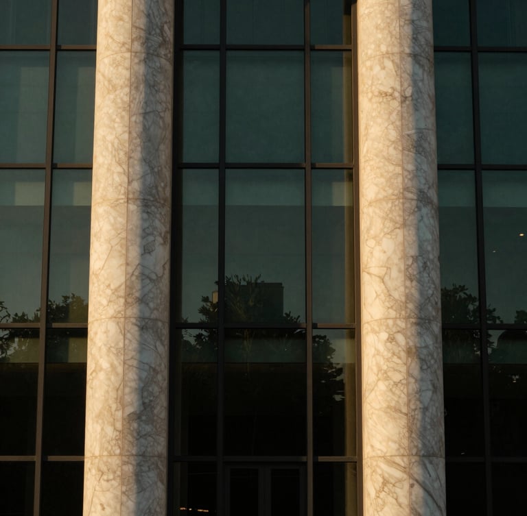 Editorial architectural close-up of a luxury concrete and glass facade, warm golden-hour sunlight reflecting on premium marble columns, symmetrical framing, 35mm