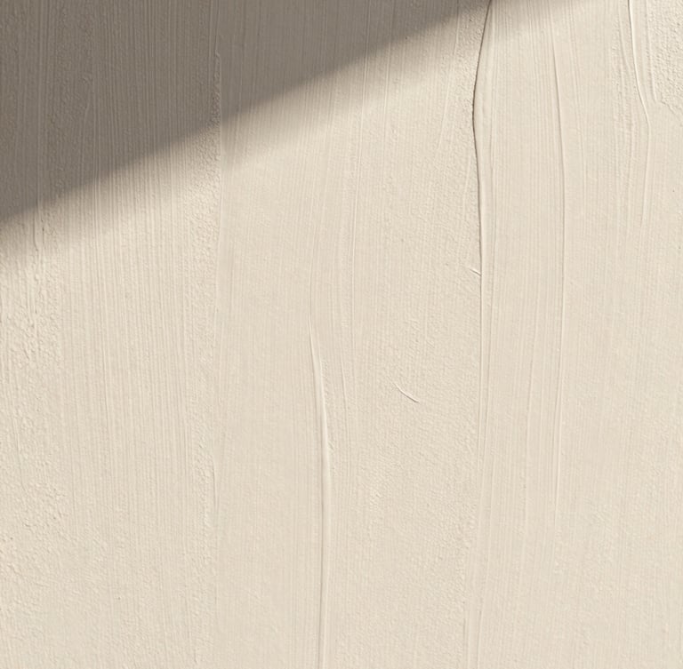 Extreme macro close-up of a hand-applied lime wash wall texture in warm chalky white, soft morning shadows casting across the subtle mineral ridges, architectural minimalist composition.