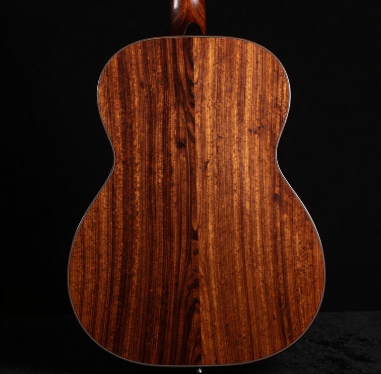 Polished guitar back made of highly figured reclaimed mahogany, catching dramatic studio side-glare, obsidian background