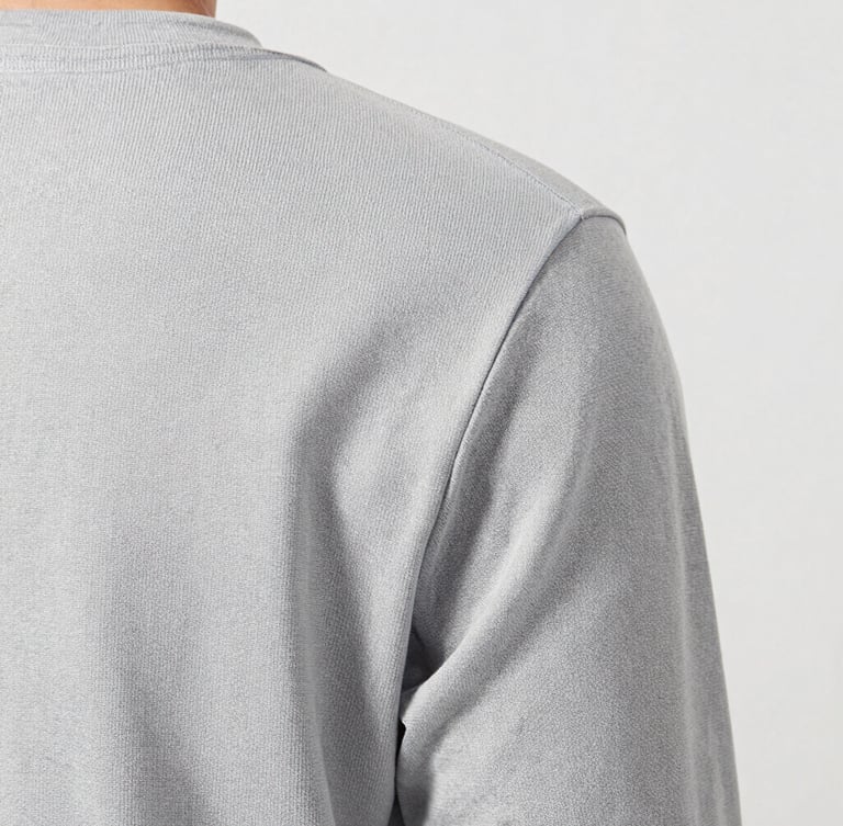 Close-up tactile detail of conscious water-resistant canvas fabric, bright soft daylight, light gray backdrop, 50mm