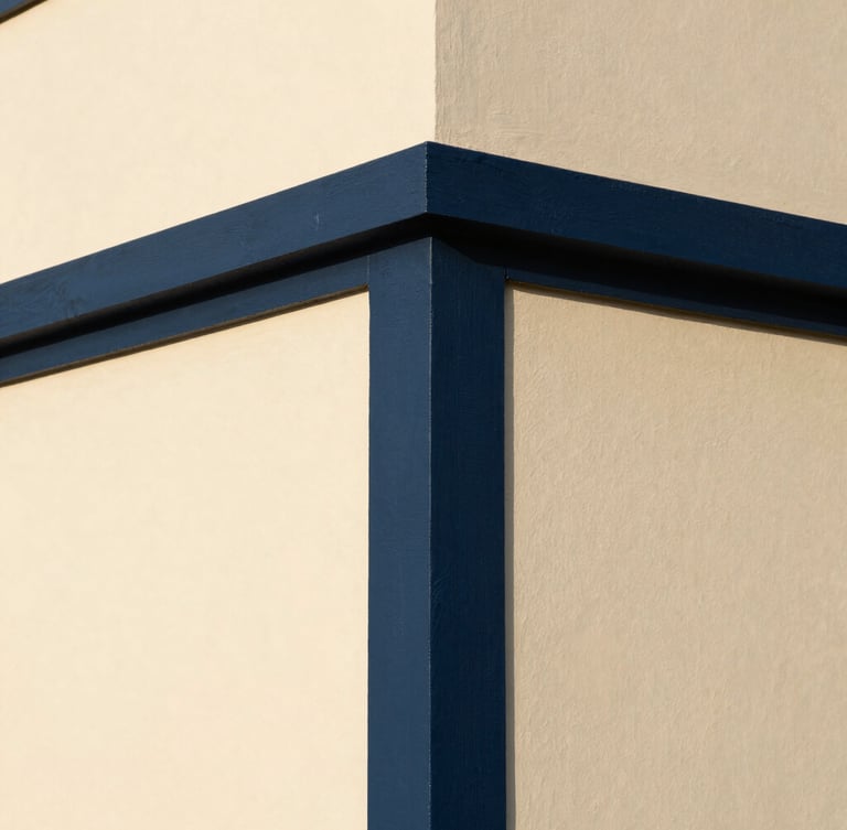 Close-up architectural shot of a perfectly painted modern wall corner, sharp high-contrast line between deep navy and warm cream, natural light, 35mm lens.