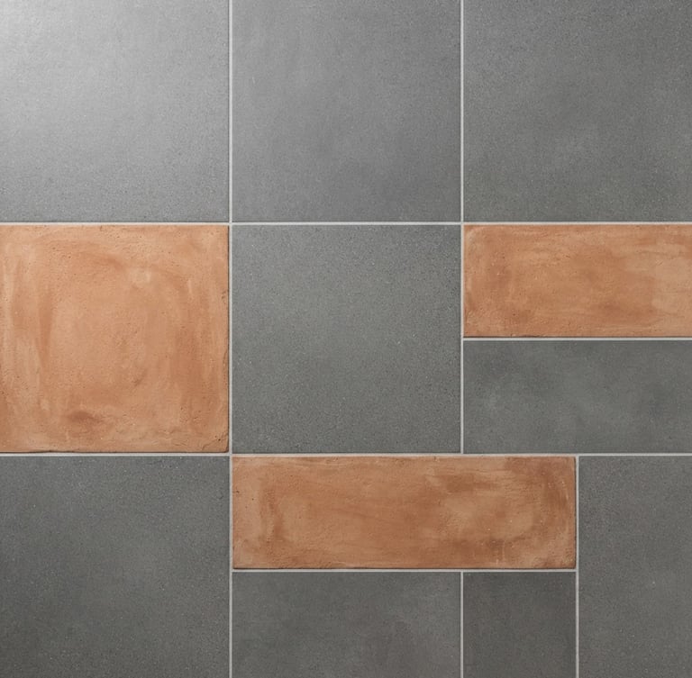Straight-on architectural flat lay of large-format vitrified tile slabs in matte gray and terracotta clay tones, bright natural daylight, sharp focus