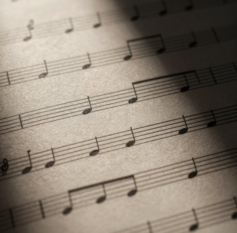 Close-up macro shot of elegant, high-contrast musical notation on thick textured cream paper, dramatic chiaroscuro lighting with deep shadows casting across the staff lines, 35mm anamorphic lens