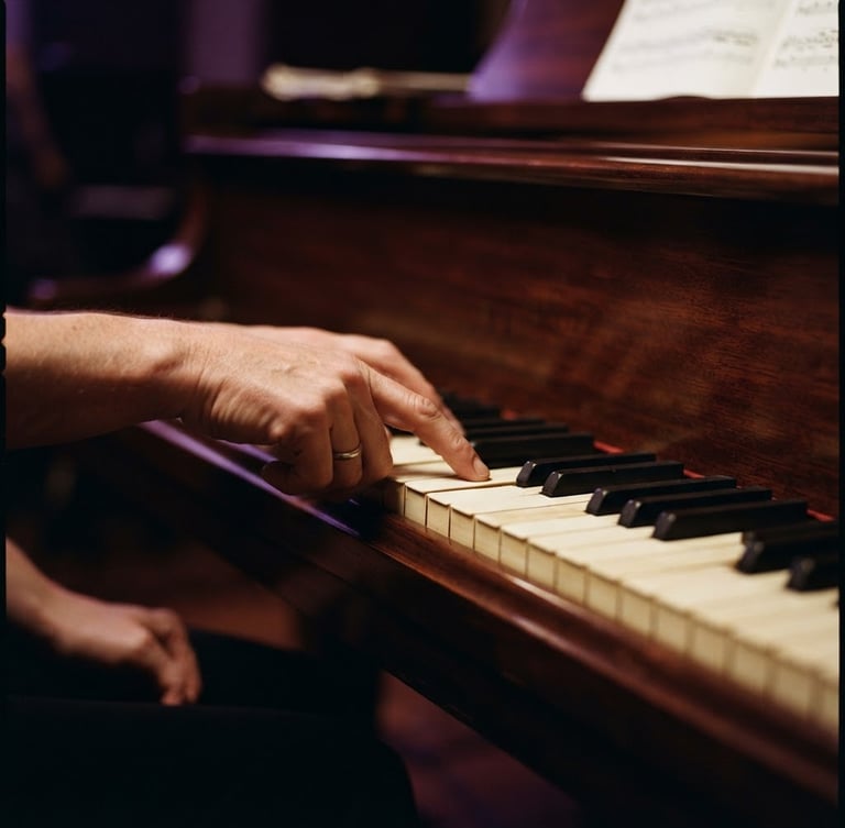 A close-up of hands guiding a student's fingers on a polished mahogany piano, warm studio lighting with subtle purple backlights, rich deep tones, shallow depth of field, 85mm lens