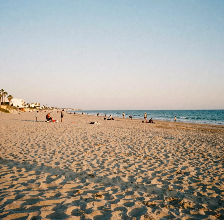 A wide panoramic shot of a quiet beach at dusk in Mar Menor, soft sun-drenched tones, authentic local life, 35mm photography