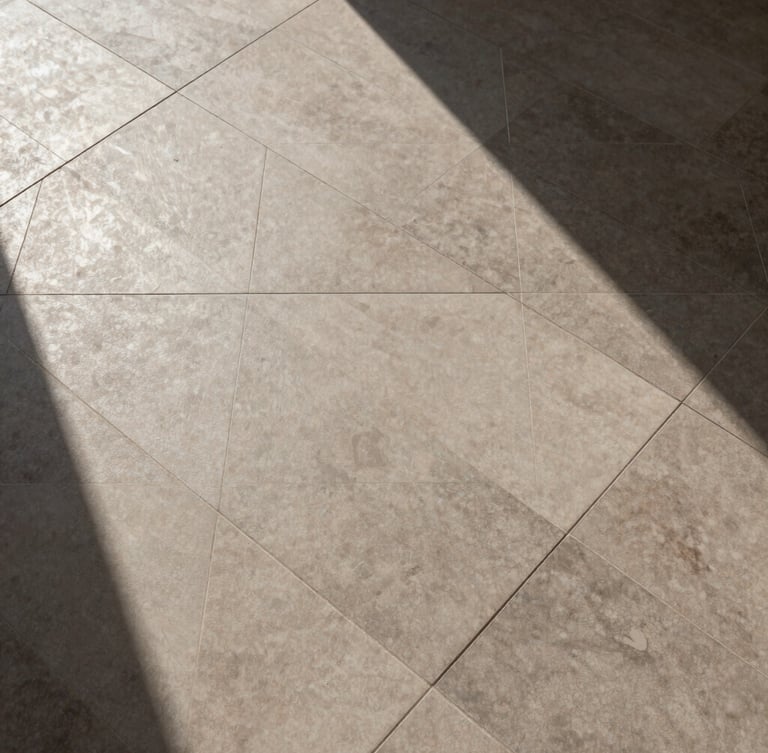Precise top-down geometric pattern of installed architectural-grade porcelain tiles, high-contrast sun and shadow, deep earth tones, 35mm