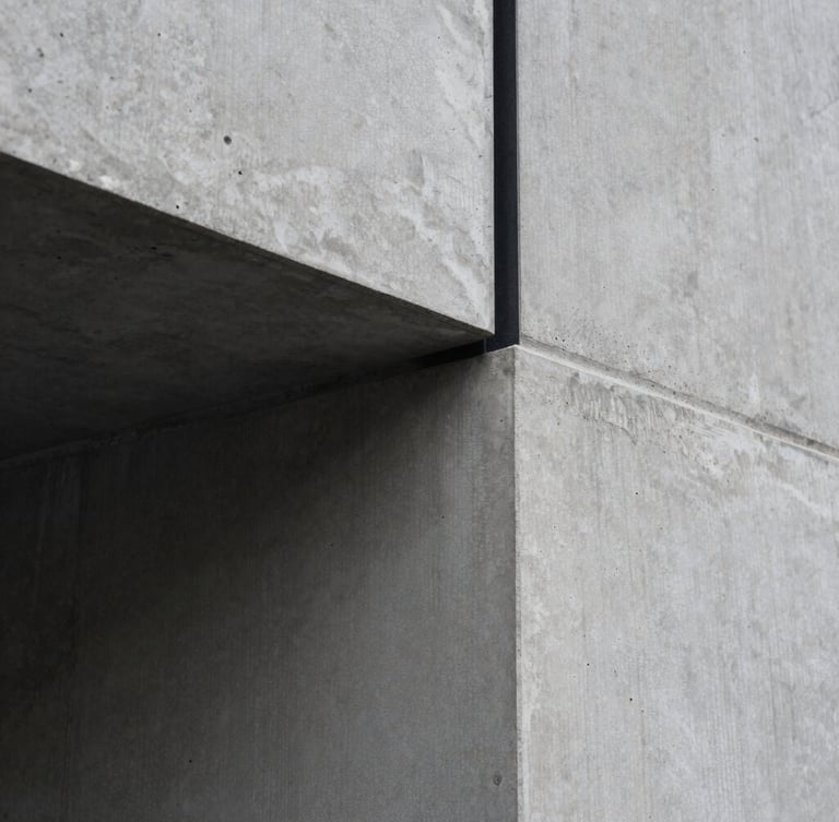 Extreme close-up of a flawless concrete pour meeting a black steel beam, sharp morning light, desaturated charcoal tones, minimalist architectural photography, 35mm