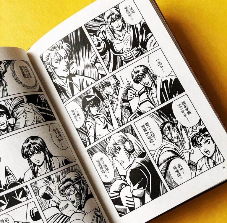 Close-up of a physical comic book held open, showing detailed black and white inked panels, heavy paper texture, warm studio light.