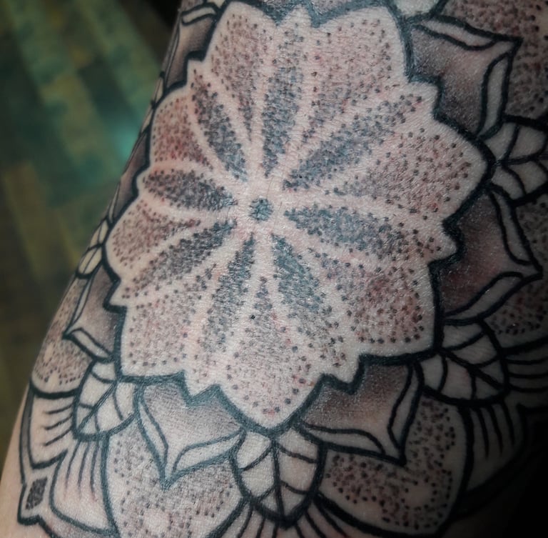 Close up of a dotwork mandala tattoo