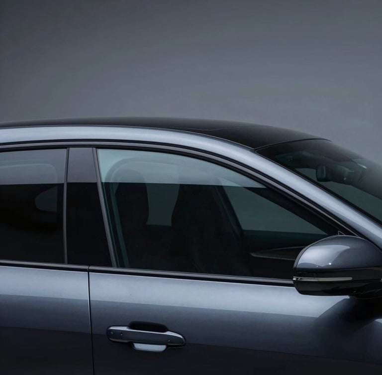 Sleek dark sports sedan side profile, flawless dark ceramic window tint, high-contrast cool studio LED lighting reflecting off clean glass, obsidian paint, macro lens, 35mm
