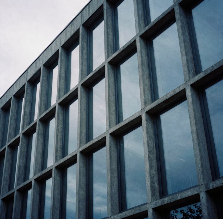 Extreme close-up of a modern concrete and glass facade in Luxembourg under cool overcast daylight, sharp architectural lines, medium format film