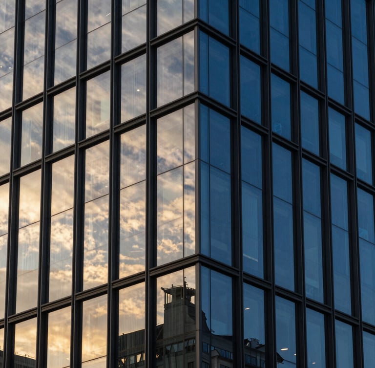 Sleek modern architectural high-rise facade, dramatic golden hour reflections, deep obsidian and royal blue tones, sharp focus, 35mm