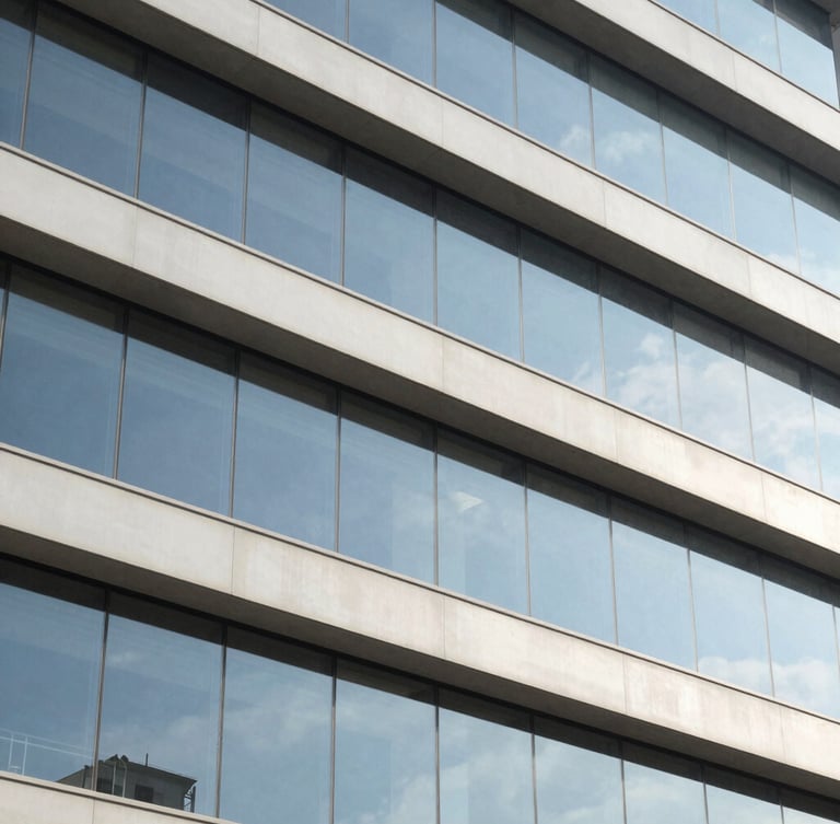 Architectural detail of a modern corporate building facade in Itajaí, clean lines, glass reflections, bright daylight with soft blue shadows, 35mm lens