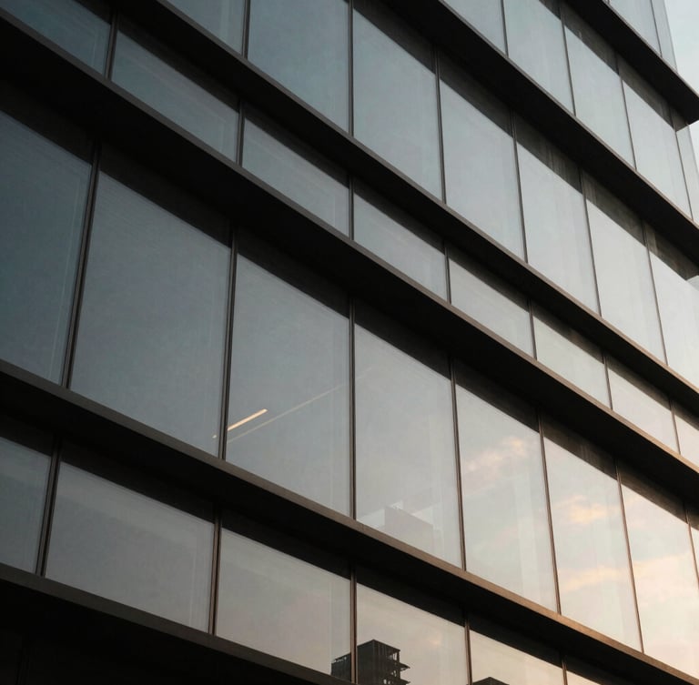 Close-up of clean structural glass joints and black steel frames in a modern building lobby, sharp architectural lines, dramatic side lighting, desaturated tones