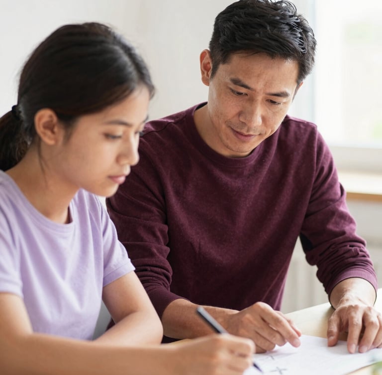 A candid medium shot of a mentor guiding a young adult through a project, warm daylight, soft lavender tones, shallow depth of field, authentic focus