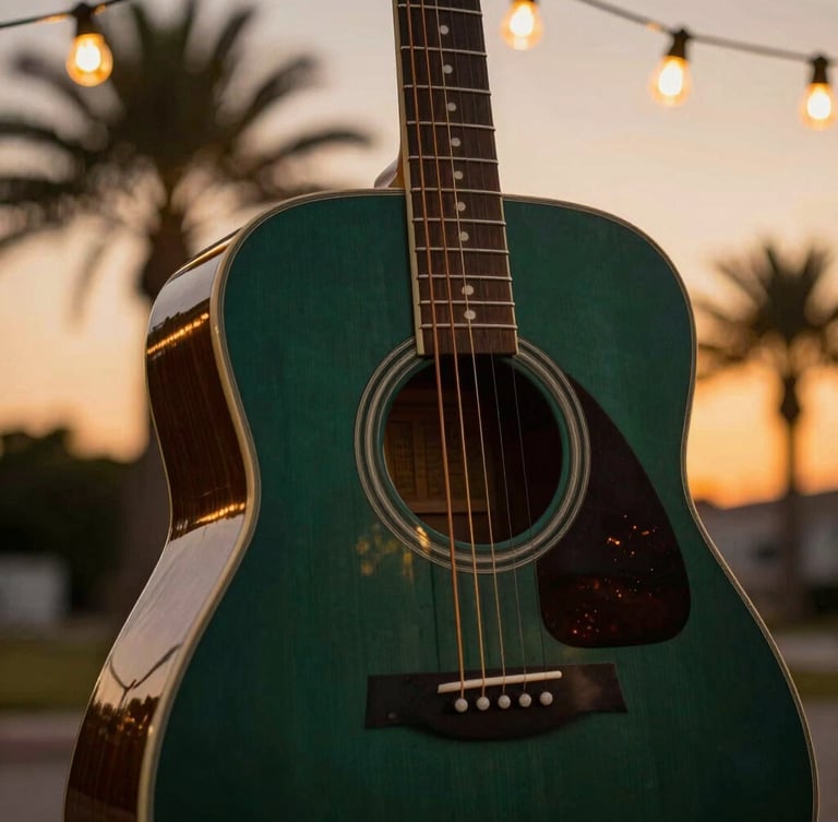 Tight shallow-depth-of-field shot of an acoustic guitar body under warm incandescent string lights, rich deep green and amber tones, palm tree silhouettes in the background.