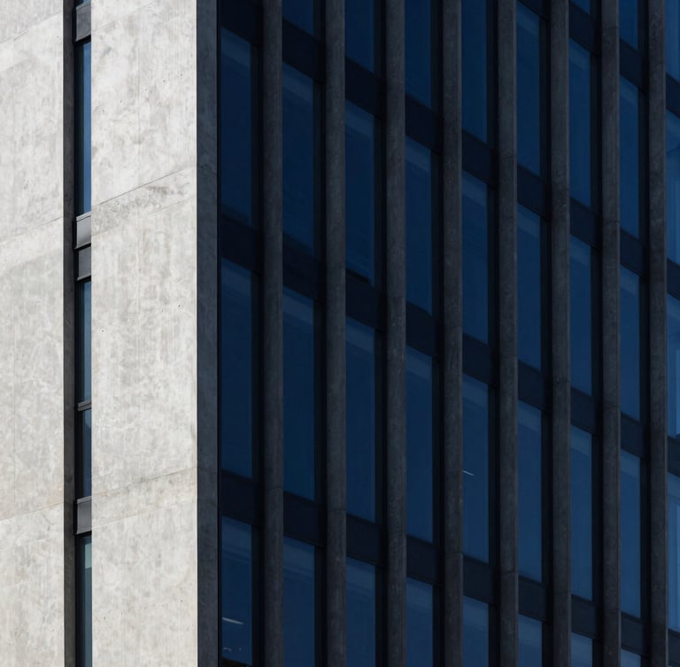 Minimalist modern concrete and glass skyscraper facade, sharp high-contrast studio light, deep indigo shadows, 35mm lens