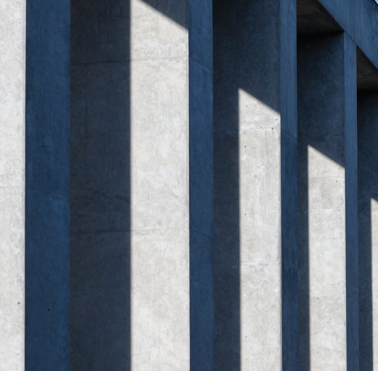 Close-up of brutalist architectural concrete columns, sharp geometric shadows, cool blue and white tones, architectural crop