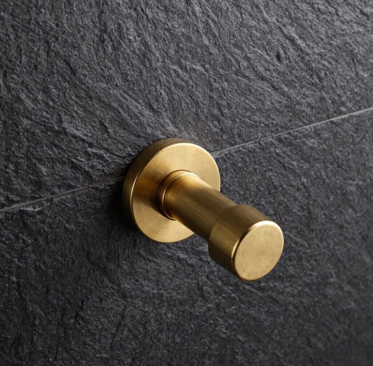 Straight-on architectural elevation of a minimalist brass shower valve installed perfectly flush against dark textured slate tiles, sharp industrial photography, 50mm