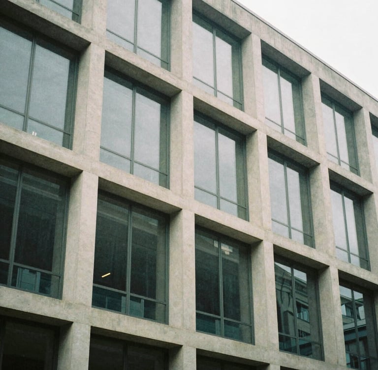 Abstract structural geometry of a mid-century modern office building facade, concrete and glass panels, soft overcast daylight, muted tones