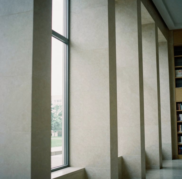 Abstract architectural geometry of a quiet stone library interior, clean vertical columns, soft diffused daylight, elegant minimalist atmosphere, 35mm film.
