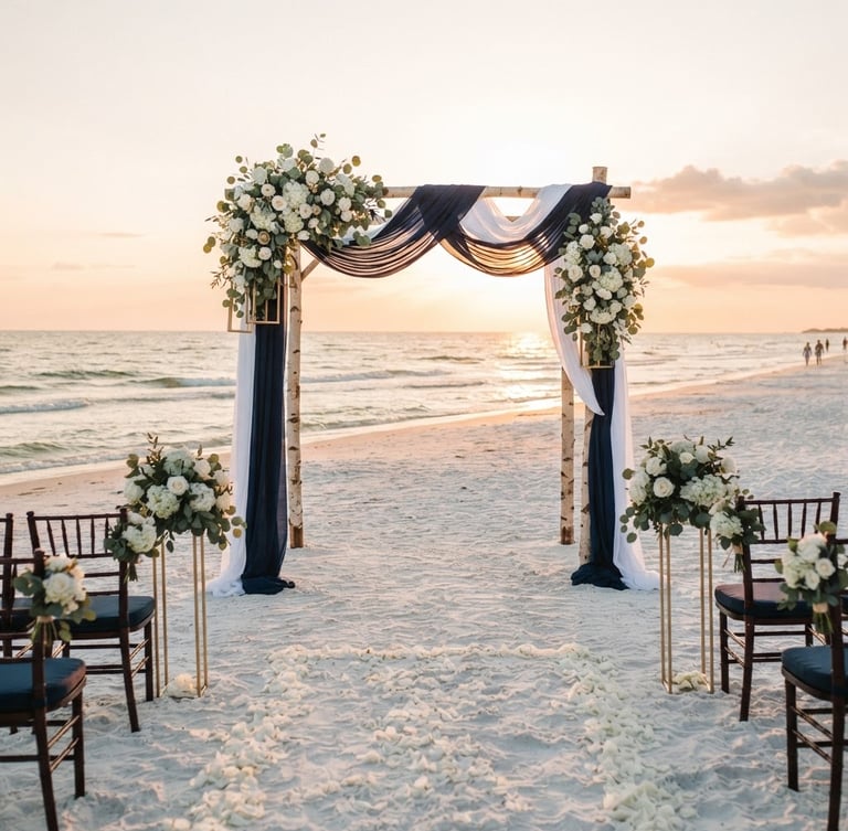 A pristine beach wedding setup at sunset on Madeira Beach, Florida. An elegant wooden arch draped in deep navy blue and crisp white linens with subtle gold floral stands. The Gulf of Mexico waves gently lapping in the background, warm golden-hour light casting long soft shadows on the clean white sand.