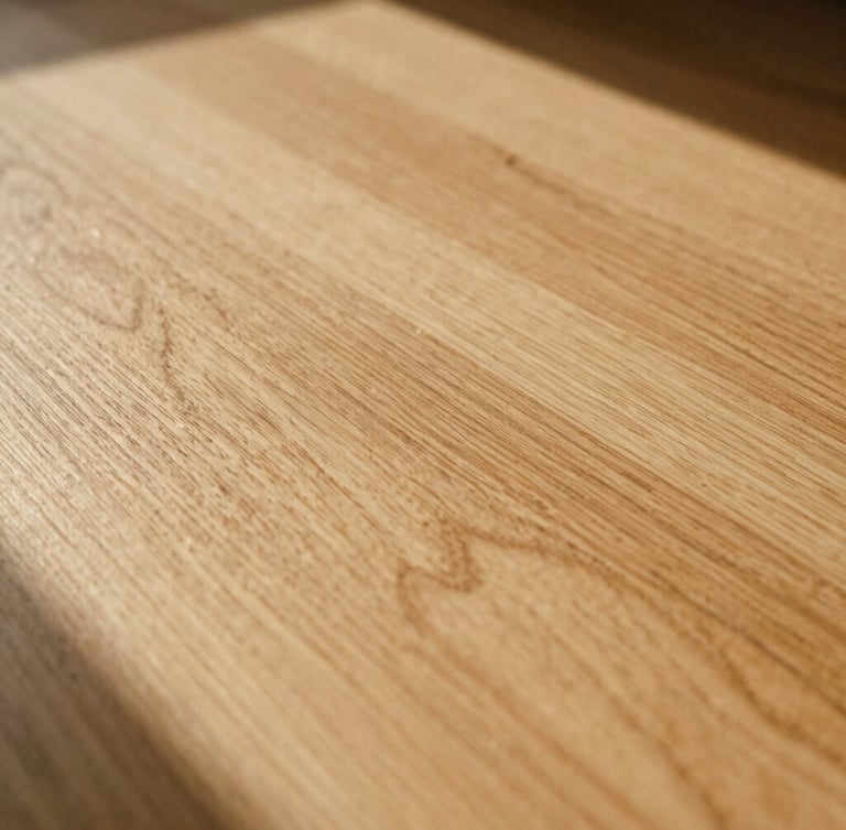 Close-up of natural sun-drenched oak wood grain showing rich texture and soft shadows, warm editorial photography, 35mm