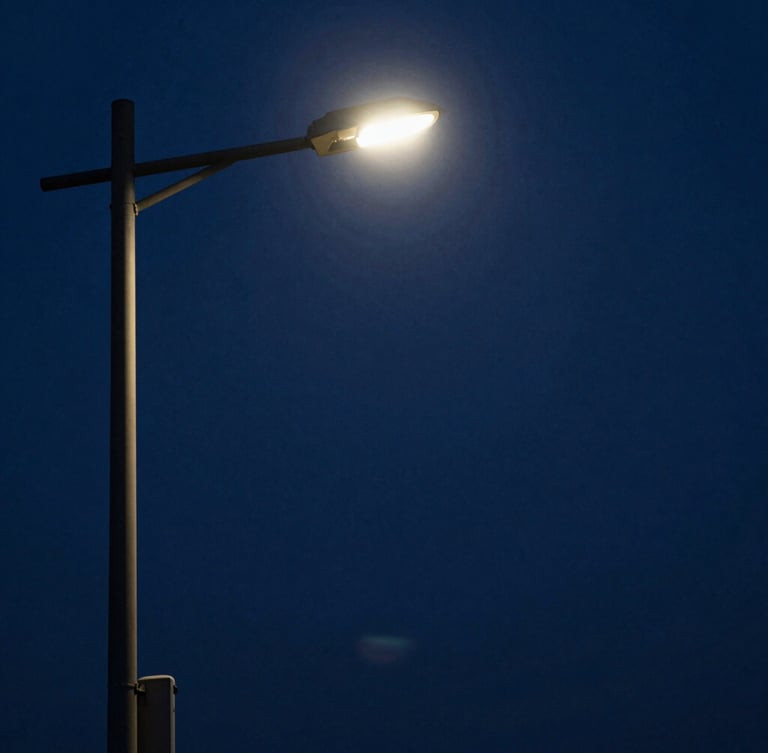 High-contrast chiaroscuro portrait of MoonJX17 under a harsh streetlamp, deep midnight-blue shadows, anamorphic framing.