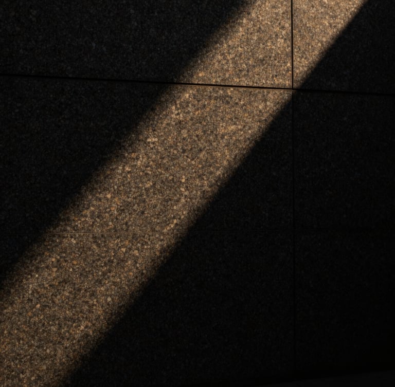 Abstract sharp shadows cast across a dark, textured granite wall, minimal architectural lines, low-key side lighting, premium quiet atmosphere