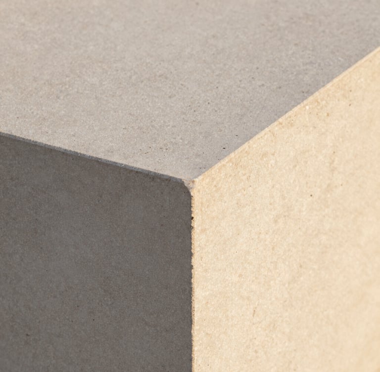 Extreme close-up of raw travertine stone texture alongside a smooth concrete edge, warm morning light, architectural detail, crisp focus