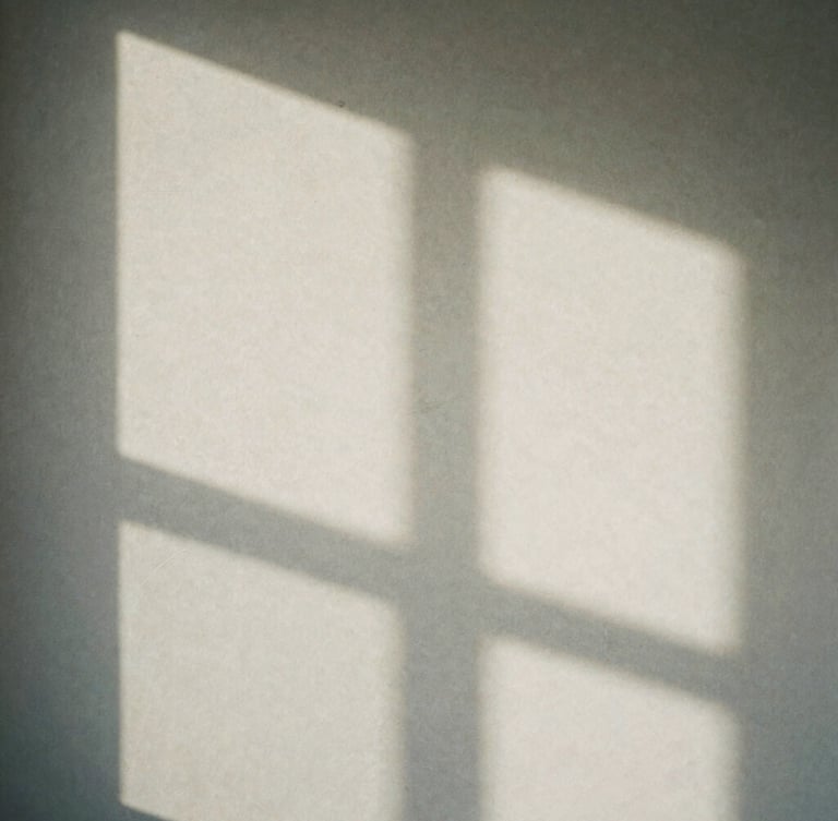 Minimalist close-up of soft shadows cast by a window frame onto a textured stone wall, soft diffused daylight, quiet contemplative atmosphere, matte paper feel